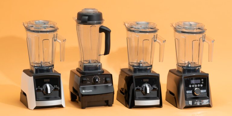 Image of four blenders side by side, black, on an orange background