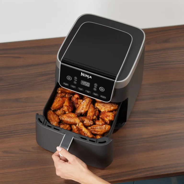 air fryer with chicken wings in it