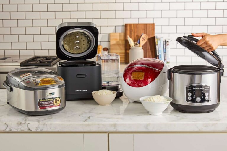 four rice cookers on a kitchen tabletop